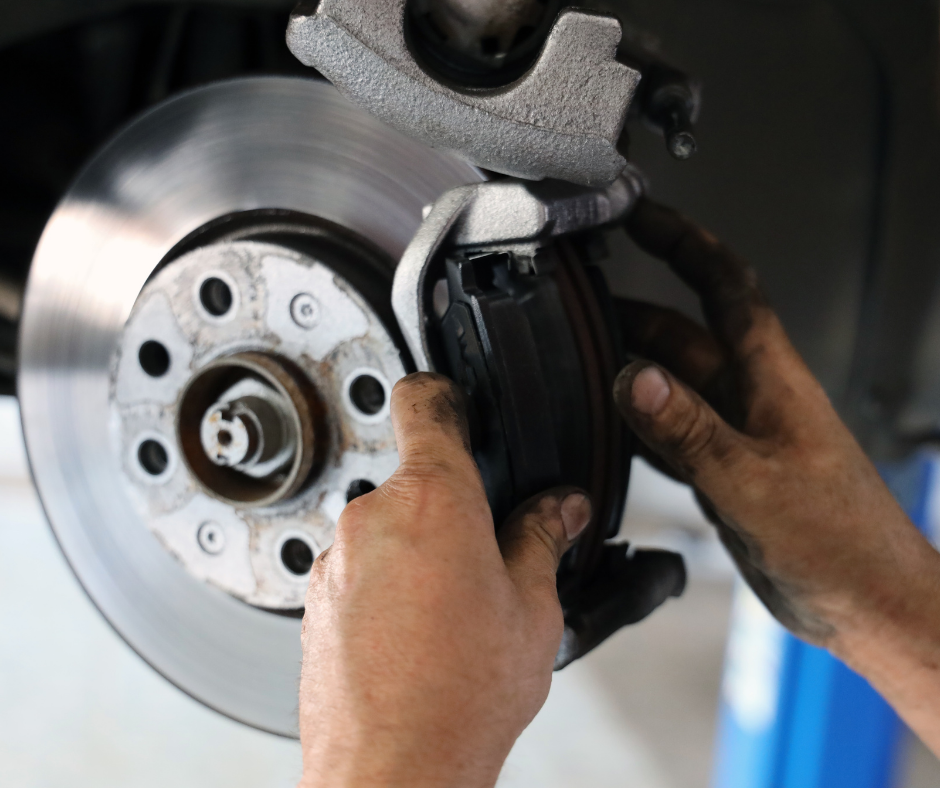 man repairing brakes