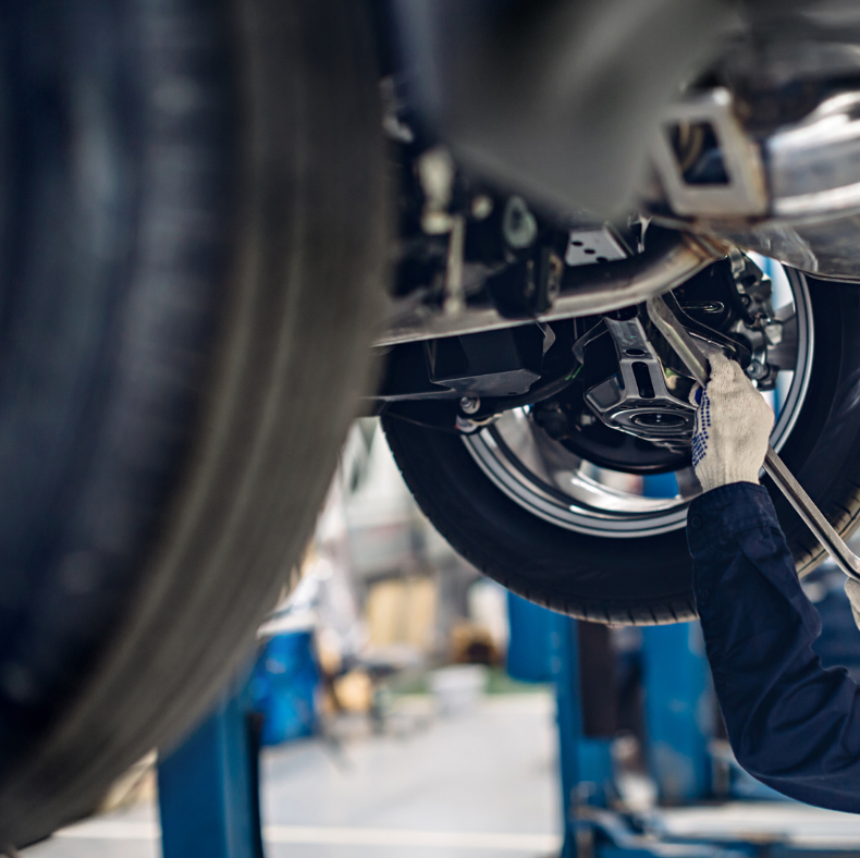 mechanic fixing car suspension